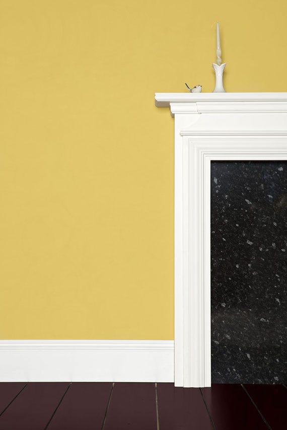 Yellow Ground No.218 by Farrow & Ball on a painted wall in a room setting